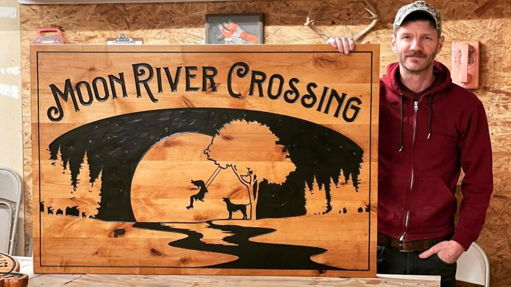 girl swinging moon river sign